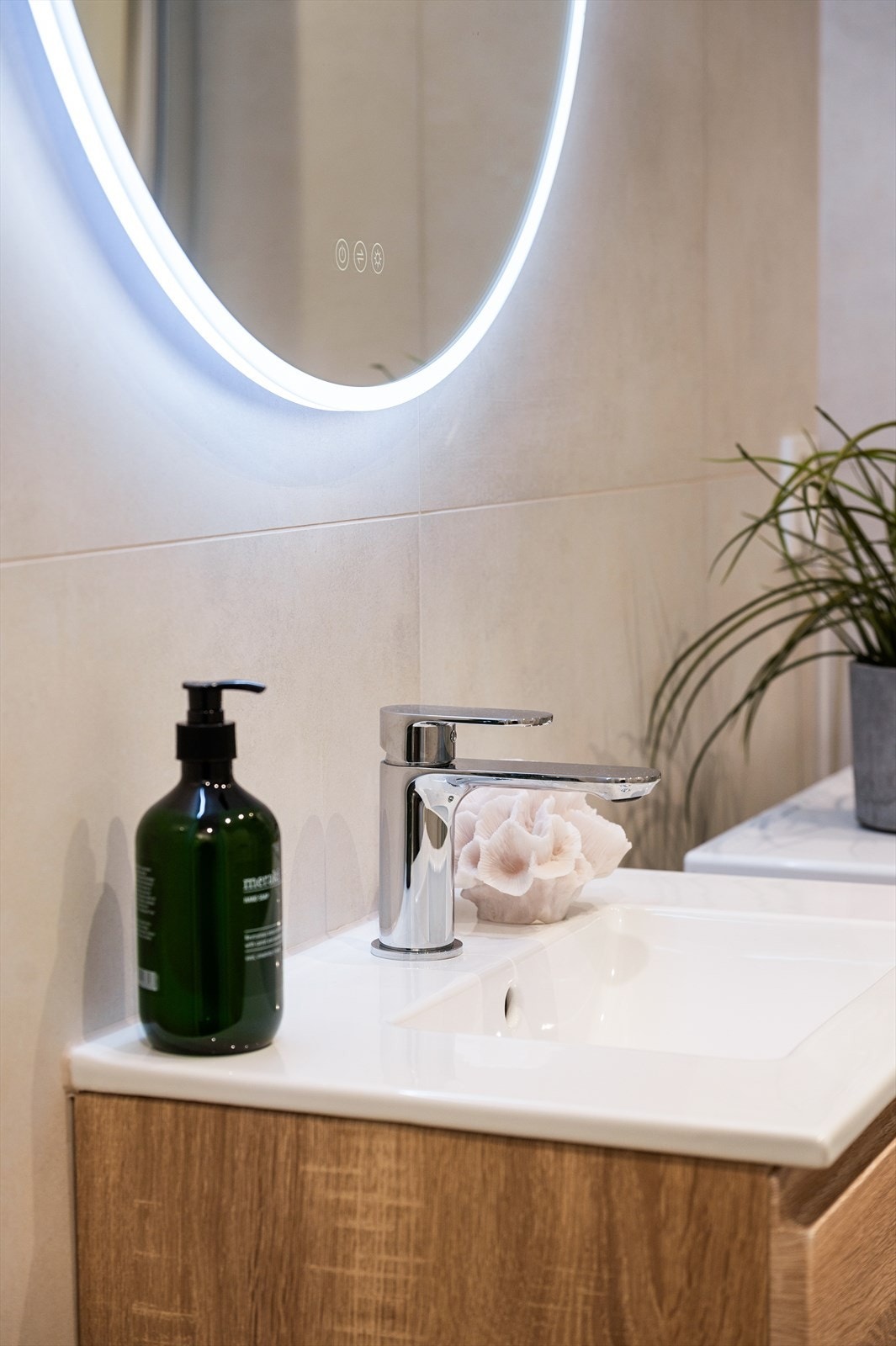 Badet er innredet med vegghengt toalett, servant nedfelt i innredning og dusjhjørne med svingbare glassdører. Galleribilde