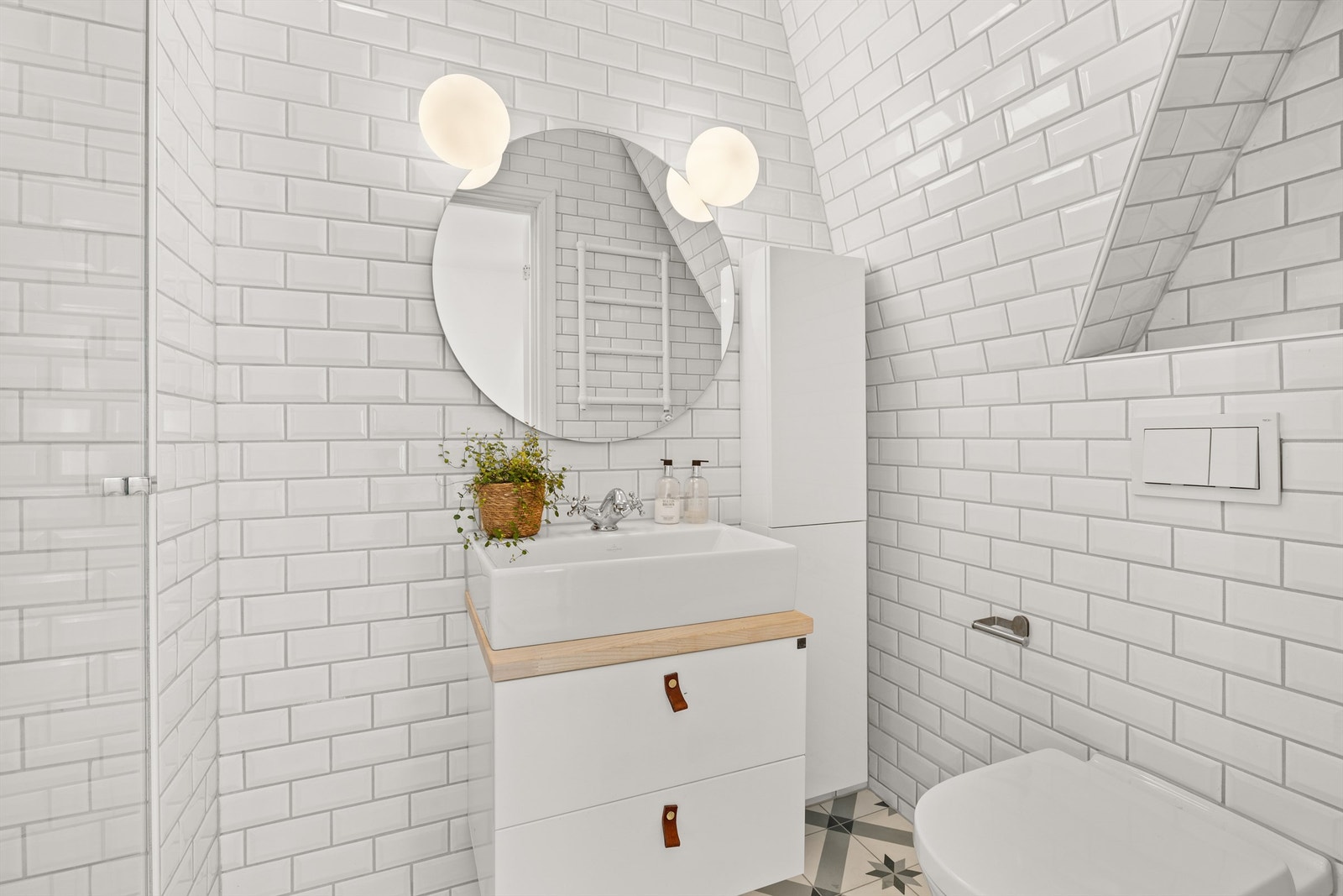 Badet tilhørende mastersuiten er delikat og innbydende og ble pusset opp i 2017. Det er utrustet med dusjnisje, veggmontert toalett og en pen, hvit servantinnredning. Galleribilde