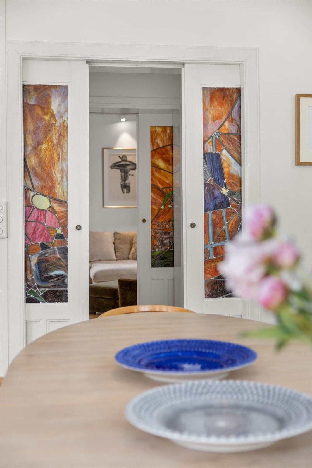 Både stuen og kjøkkenet har adkomst via tofløyede skyvedører med glassmaleri, et vakkert, kunstnerisk innslag. Galleribilde