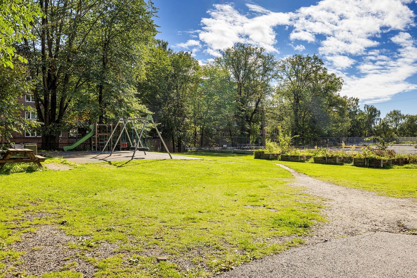 Barnevennlige fellesområder med lekeplass og sittegrupper Galleribilde