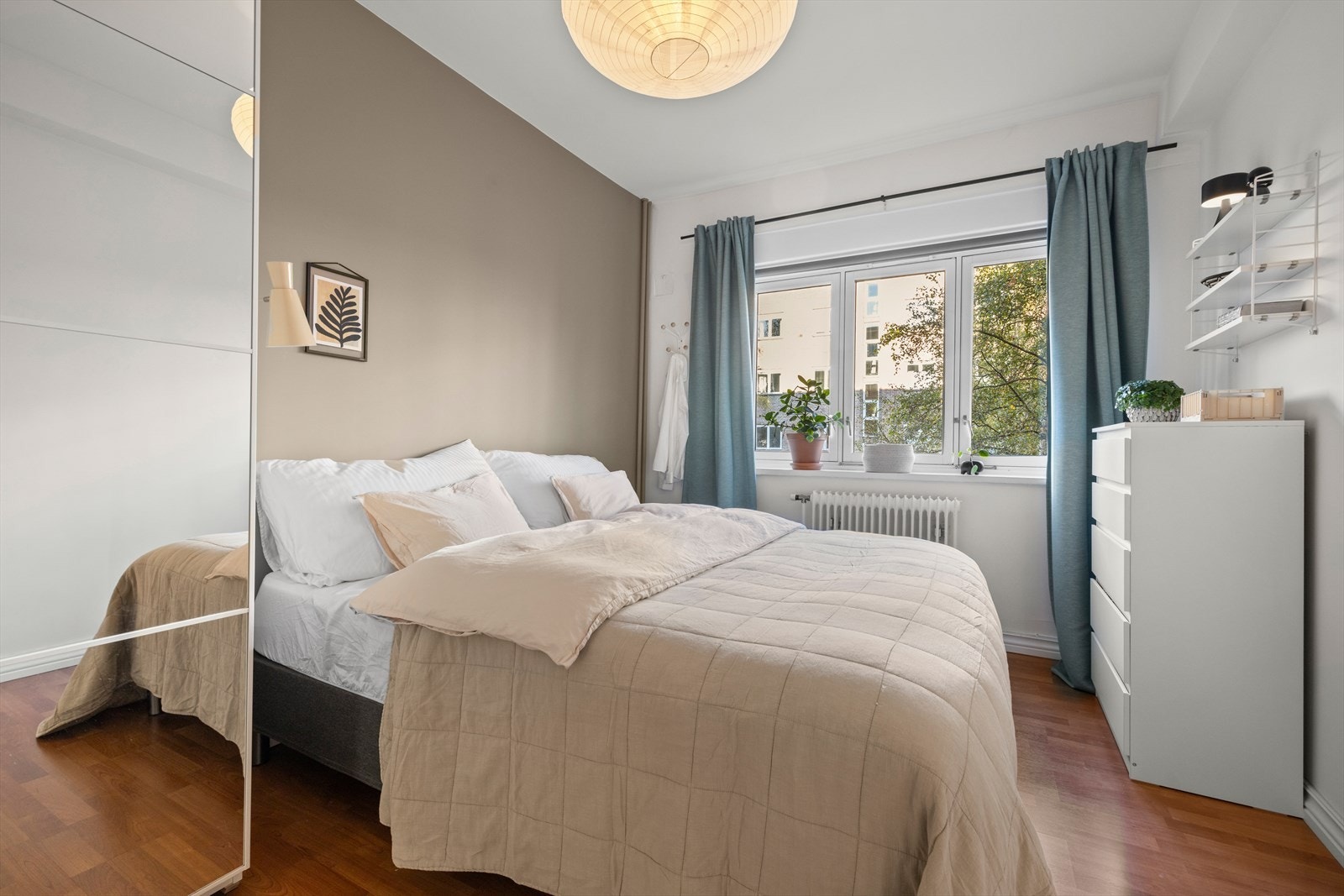 Romslig soverom med laminatgulv og malte veggoverflater Galleribilde