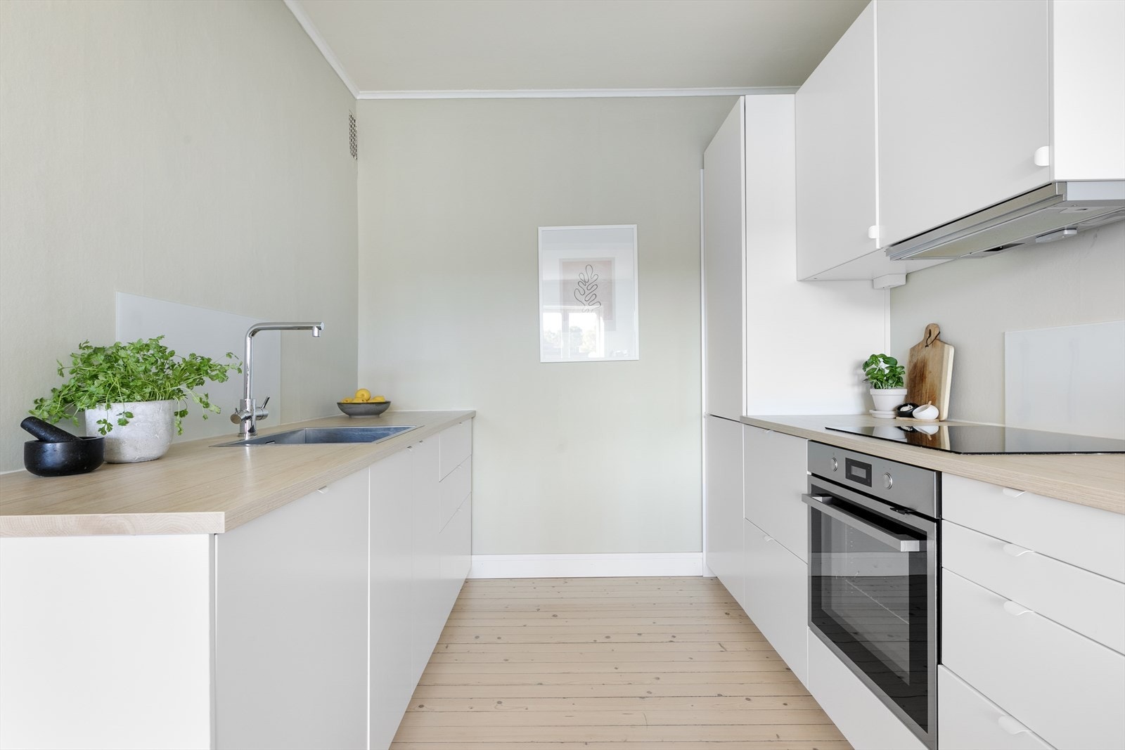 Selve kjøkkeninnredningen er praktisk plassert på hver langside av hjørnerommet. Innredningen fra Ikea ble satt inn i 2022 og har lyse fronter og laminat benkeplate. Galleribilde