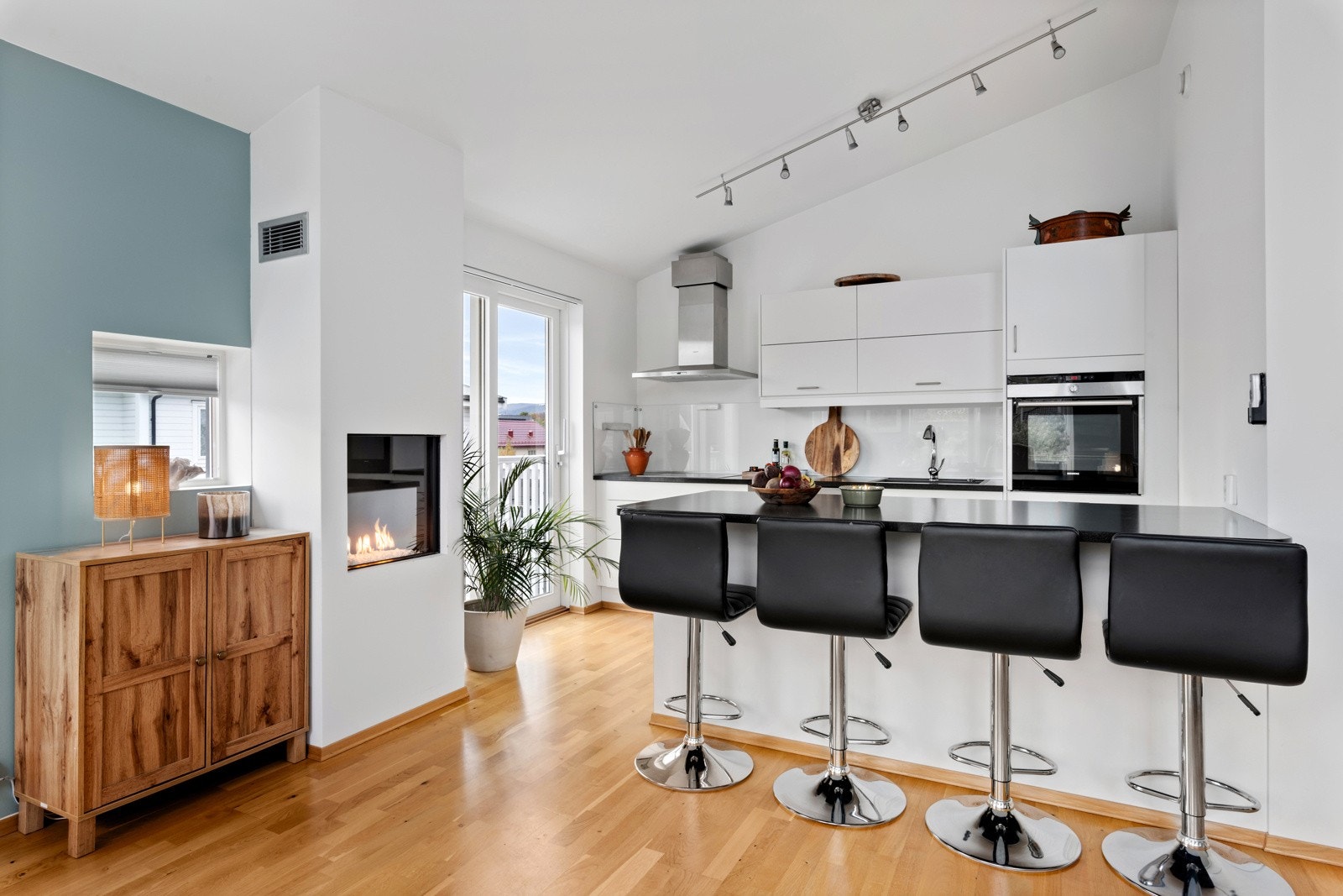 Her blir det god stemning ved kjøkkenøyen, fyr i peisen, noe godt i glasset og en middag under forberedelse. Galleribilde