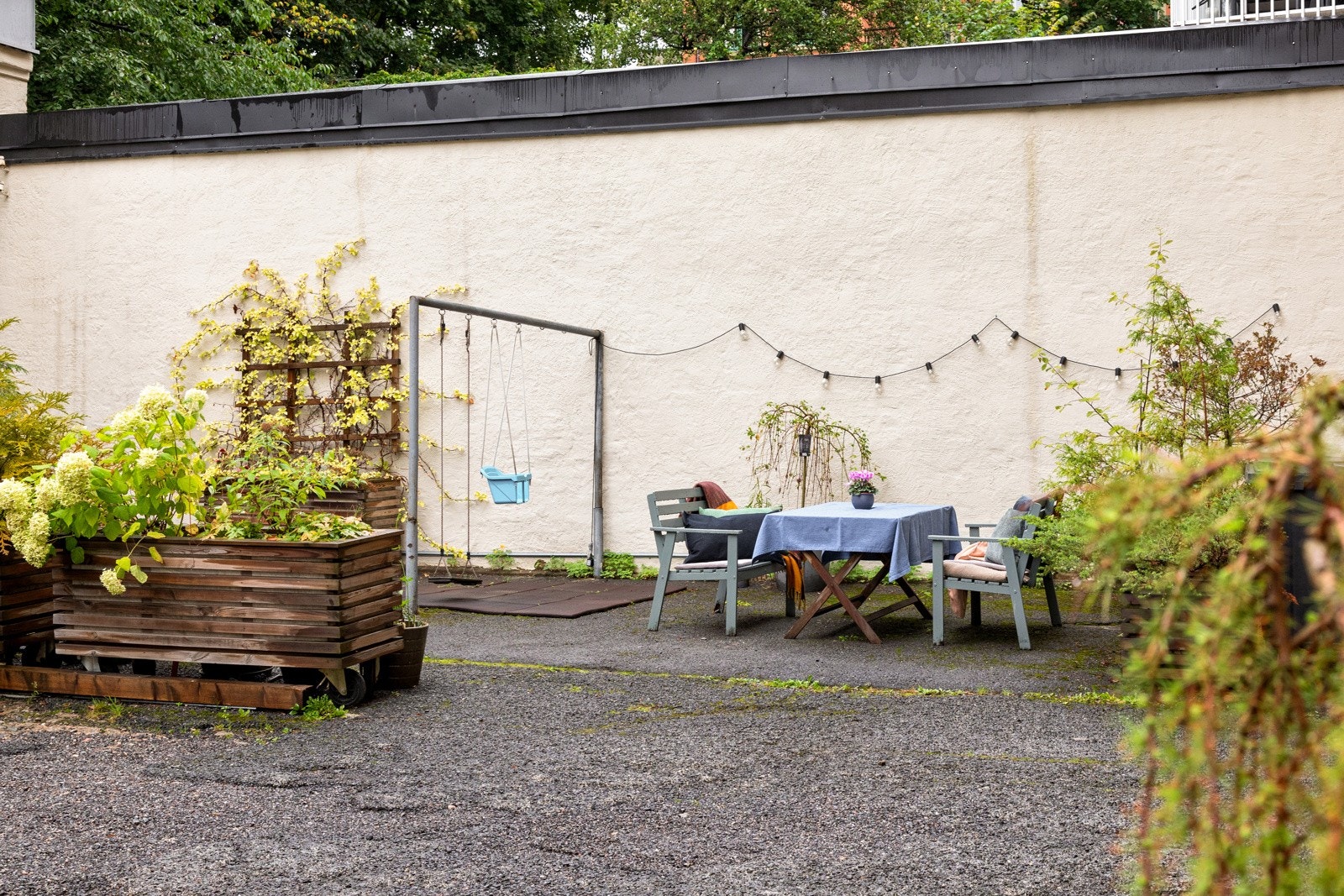 Hyggelig bakgård med beplantning og sittegruppe Galleribilde