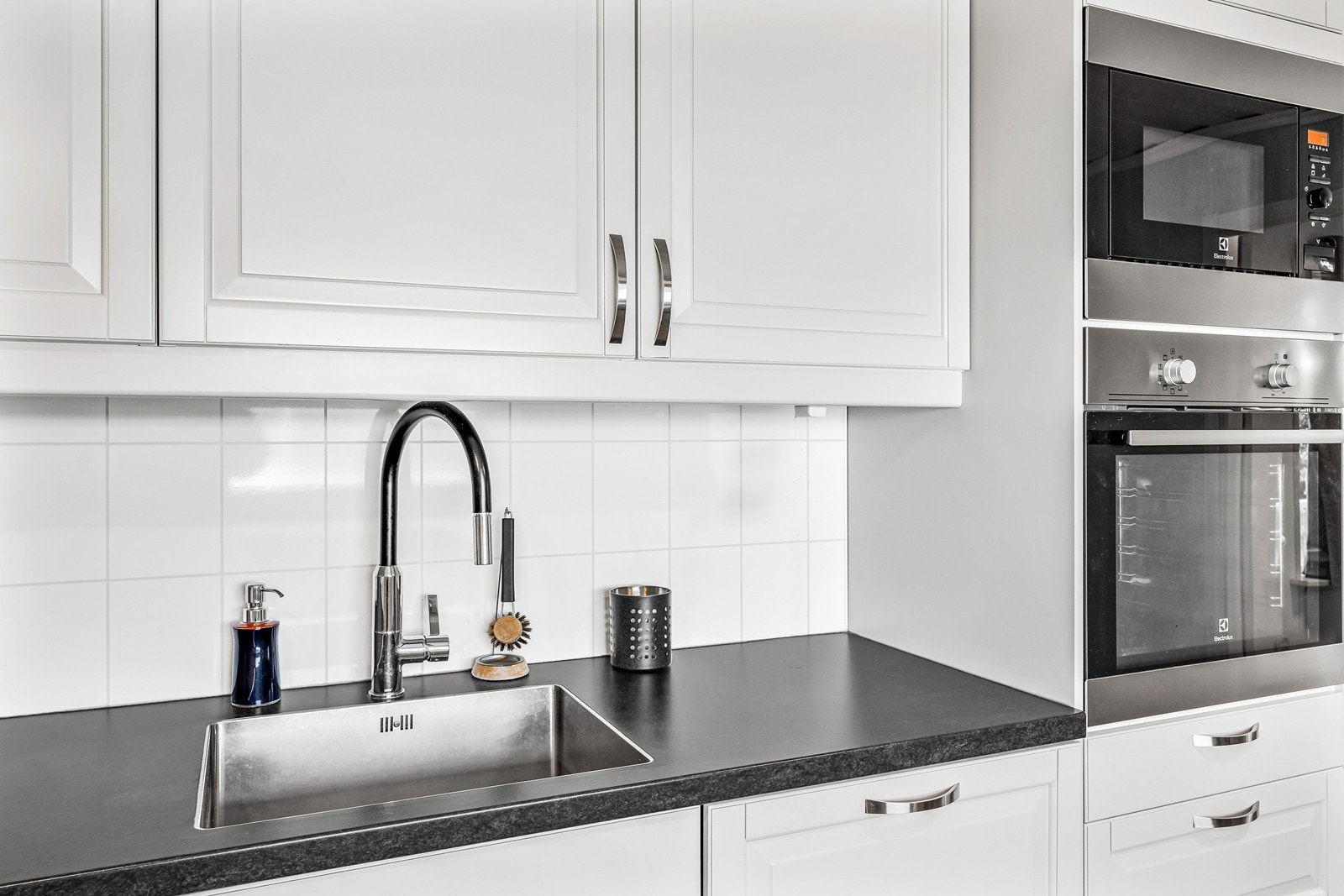 Kjøkkenet er utstyrt med oppvaskmaskin, kjølehjørne, mikrobølgeovn, stekeovn og platetopp, som sikrer funksjonalitet og praktiske løsninger for daglig bruk Galleribilde