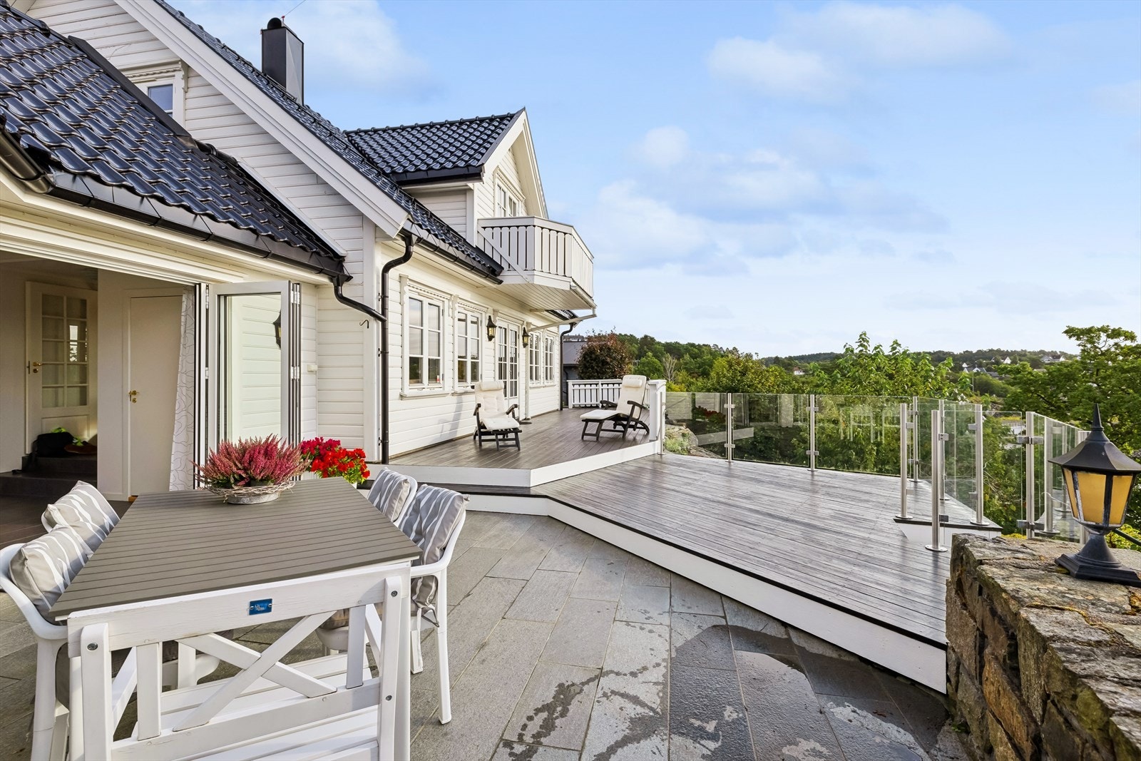 Uteområdet er delikat og helhetlig. Opparbeidet med steinlagte soner og terrasser med utgang fra flere rom i boligen Galleribilde
