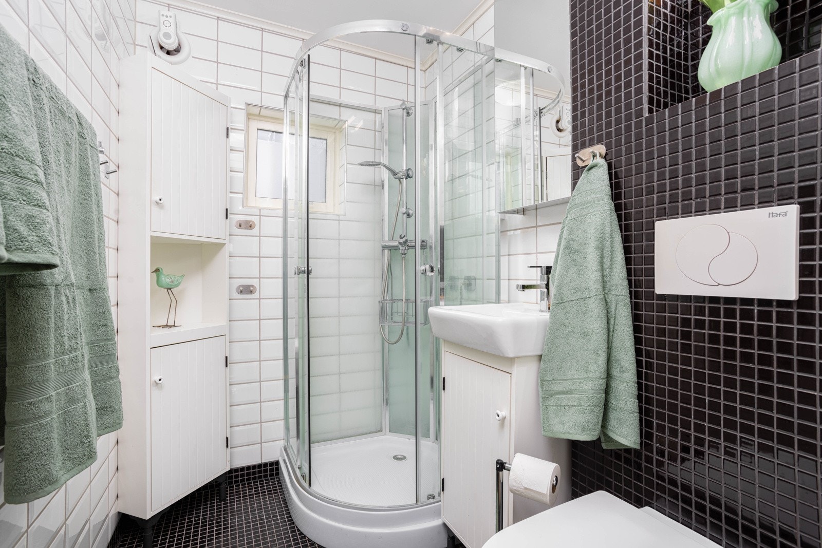 Leilighetens flislagte bad ble også renovert i 2011 og kombinerer lyse og mørke fliser. Varmekabler i gulvet. Galleribilde