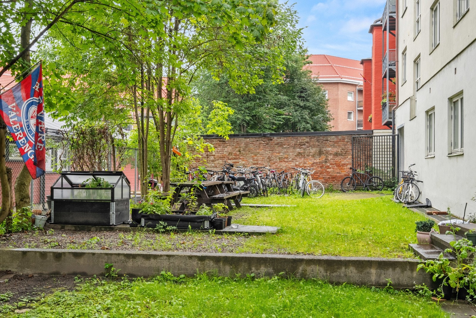 Flott opparbeidet og usjenert felleshage med sittegrupper og beplantningskasser til fri bruk for beboerne. Galleribilde