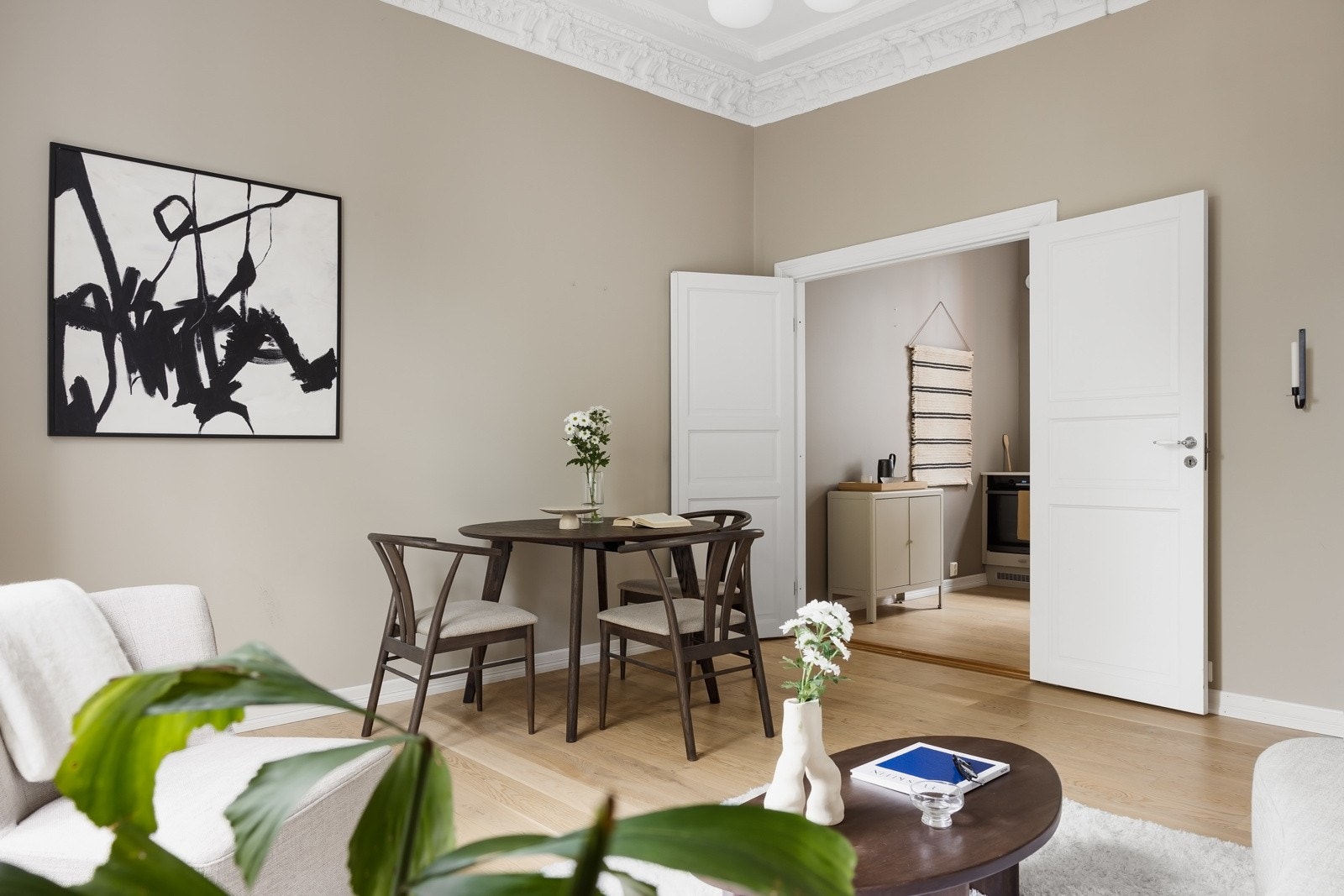 I stuen er det takrosetter og stukkatur som setter et tradisjonelt preg over den ellers moderne leiligheten. Galleribilde