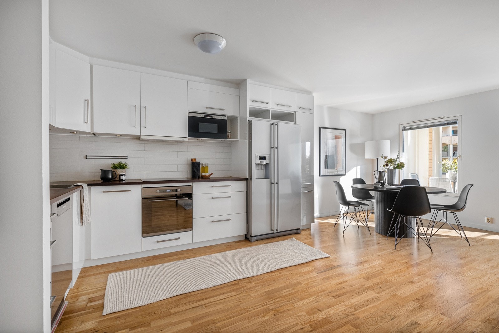 Kjøkkenet er utstyrt med frittstående kjøleskap og oppvaskmaskin og innfelt komfyr. Galleribilde