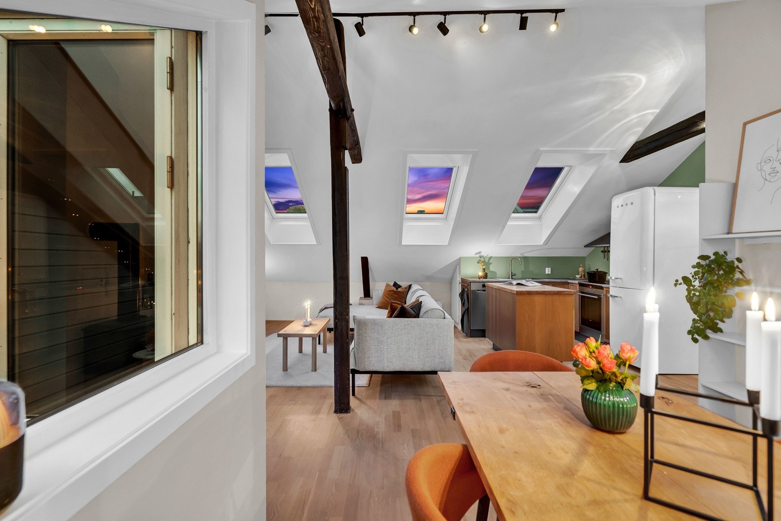 Tre nydelige vindusposter fra taket bidrar til en koselig atmosfære og naturlig sollys. Galleribilde