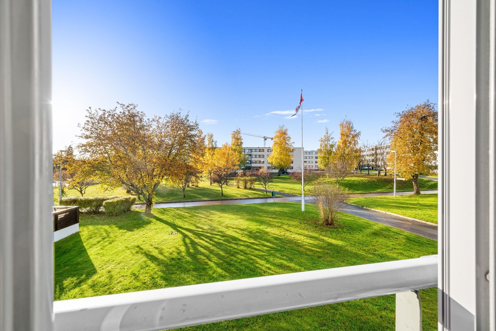 Utsikt mot grønne fellesareal fra balkongen. Galleribilde