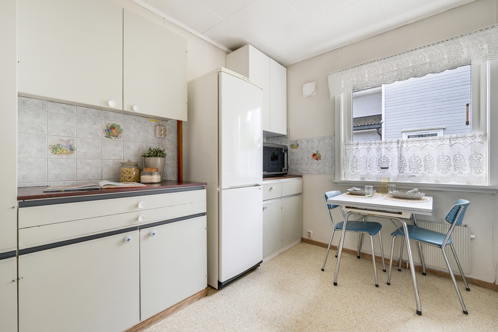 Det er god benkeplass på kjøkkenet. Det er fliser mellom benken og overskapene. Galleribilde