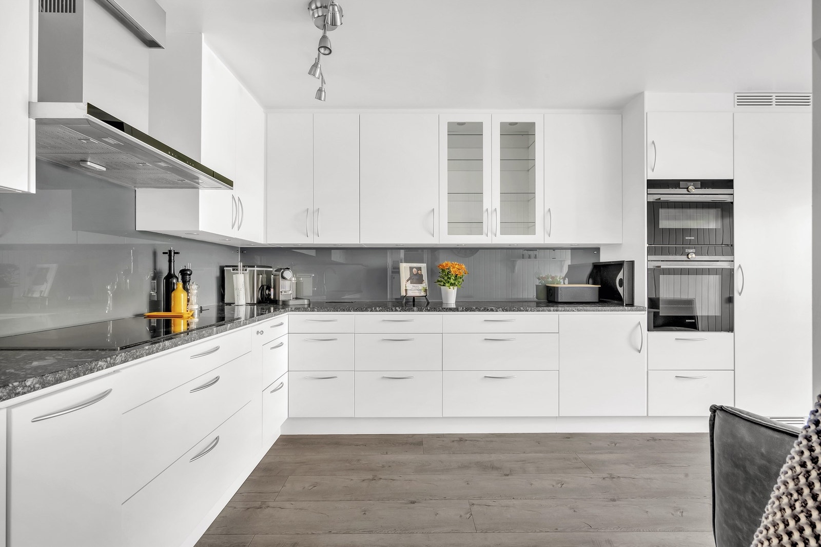 Moderne kjøkken fra 2016 med slette fronter og et overskap med innfelt glassfelt Galleribilde