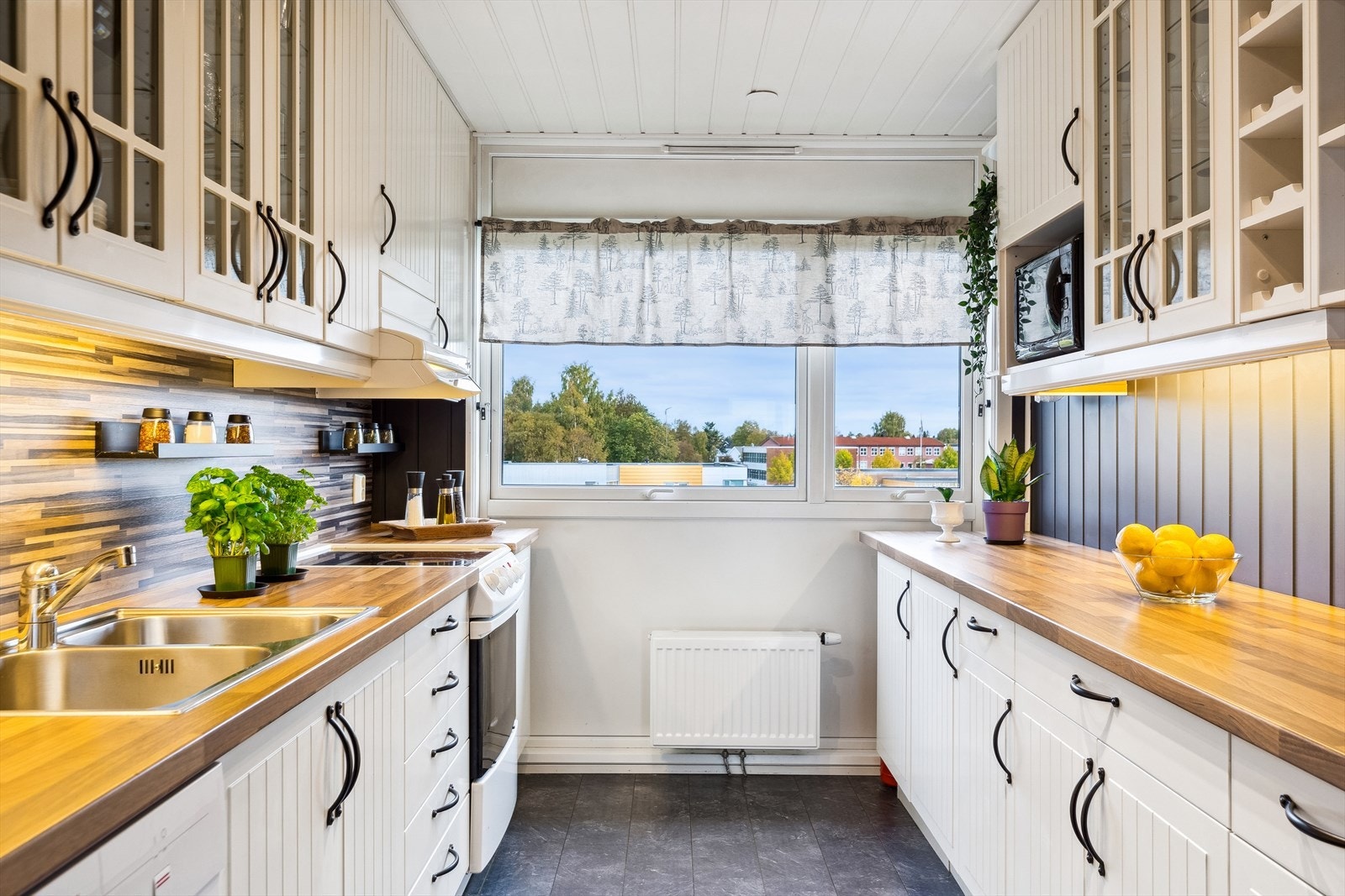 Innenfor stuen har leiligheten et kjøkken med god skap- og benkeplass langs to vegger. Galleribilde