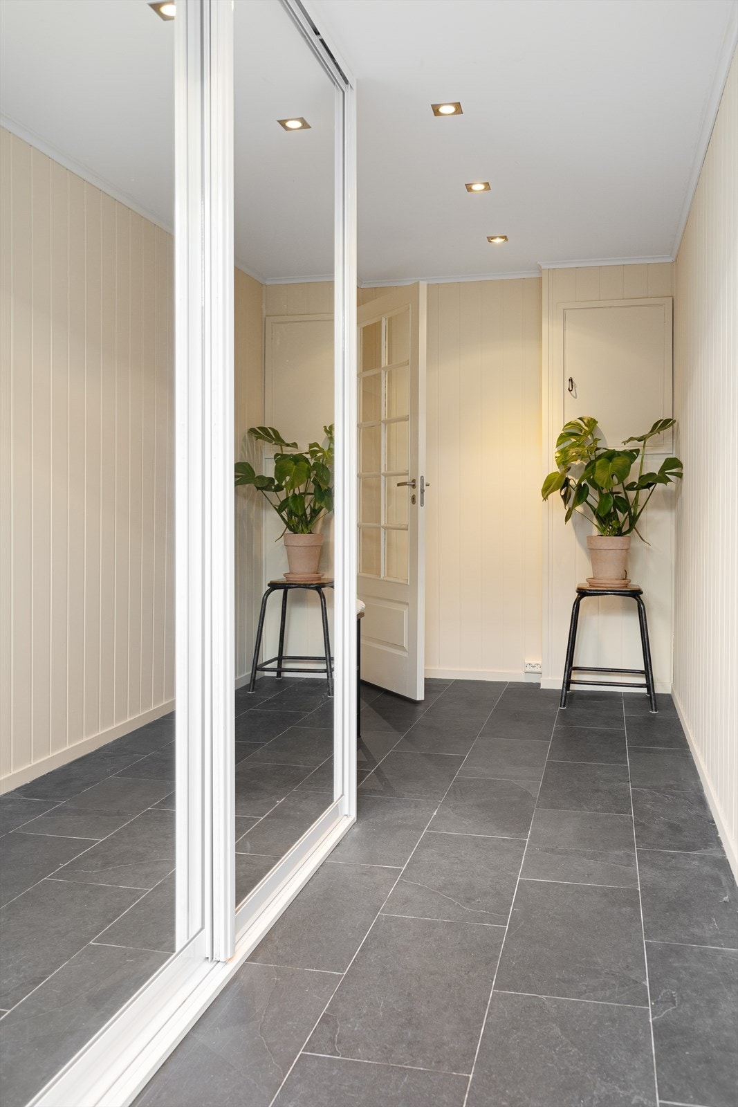 Boligens inngangsparti ligger i 1. etasje. Her blir du møtt av en innbydende og romslig entré med fliser og varme i gulv, samt god plass til ytterjakker og sko i skyvedørsgarderobe. Downlights i tak. Galleribilde