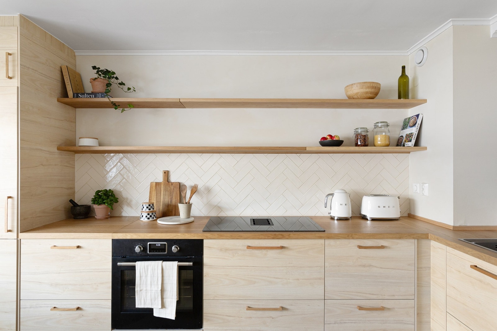 Det er rikelig med benke- og skapplass, samt integrerte hvitevarer som inkluderer: nedfelt induksjonstopp med integrert kjøkkenventilator, komfyr, kjøleskap og fryseskap, og oppvaskmaskin. Galleribilde