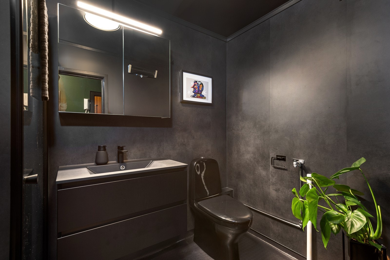 Boligens bad ble pusset opp i 2021 med baderomsplater på vegger og slitesterkt gummibelegg på gulv. Galleribilde