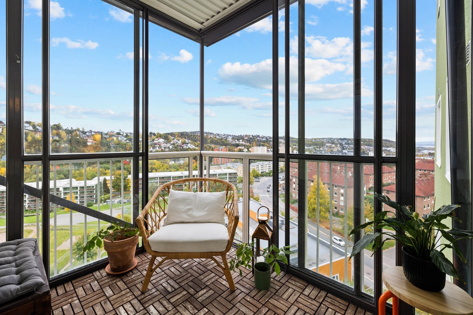 Balkongen har terrasseheller og et luftig rekkverk av stål og glass Galleribilde