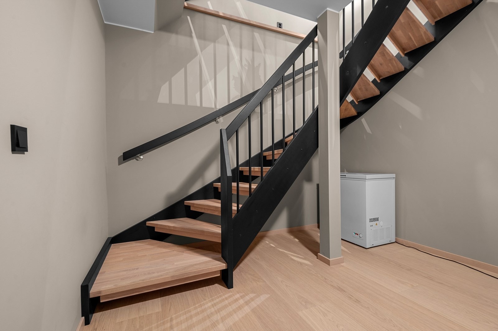 Kjelleren er i dag innredet med stue/kjøkken, sovealkove og bad. I tillegg er det en stor bod på 18m² som gir godt med plass til ønsket oppbevaring Galleribilde