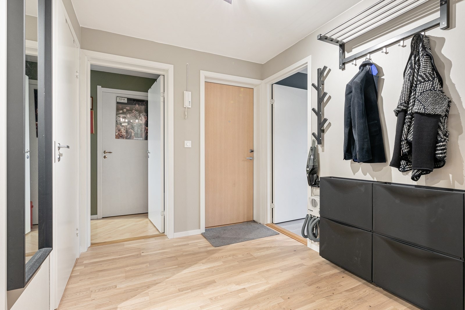 Lys og innbydende entre med fine løsninger for oppheng av yttertøy og sko Galleribilde