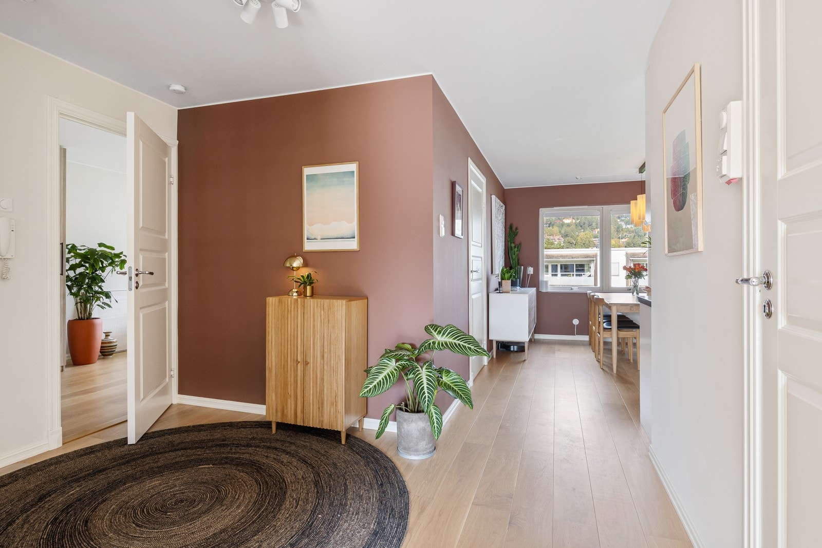 Overgangen til kjøkkensonen markeres av vegger malt i en varm terrakottafarge, som passer utmerket til et kjøkken. Galleribilde