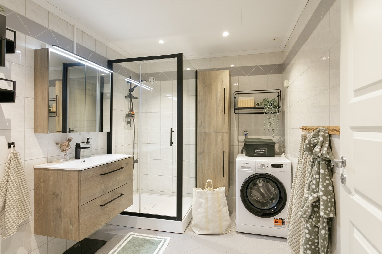 Lyst og flott bad med spotter i himling som i kombinasjon med overlyset til speilskapet gir en god lyssetting Galleribilde