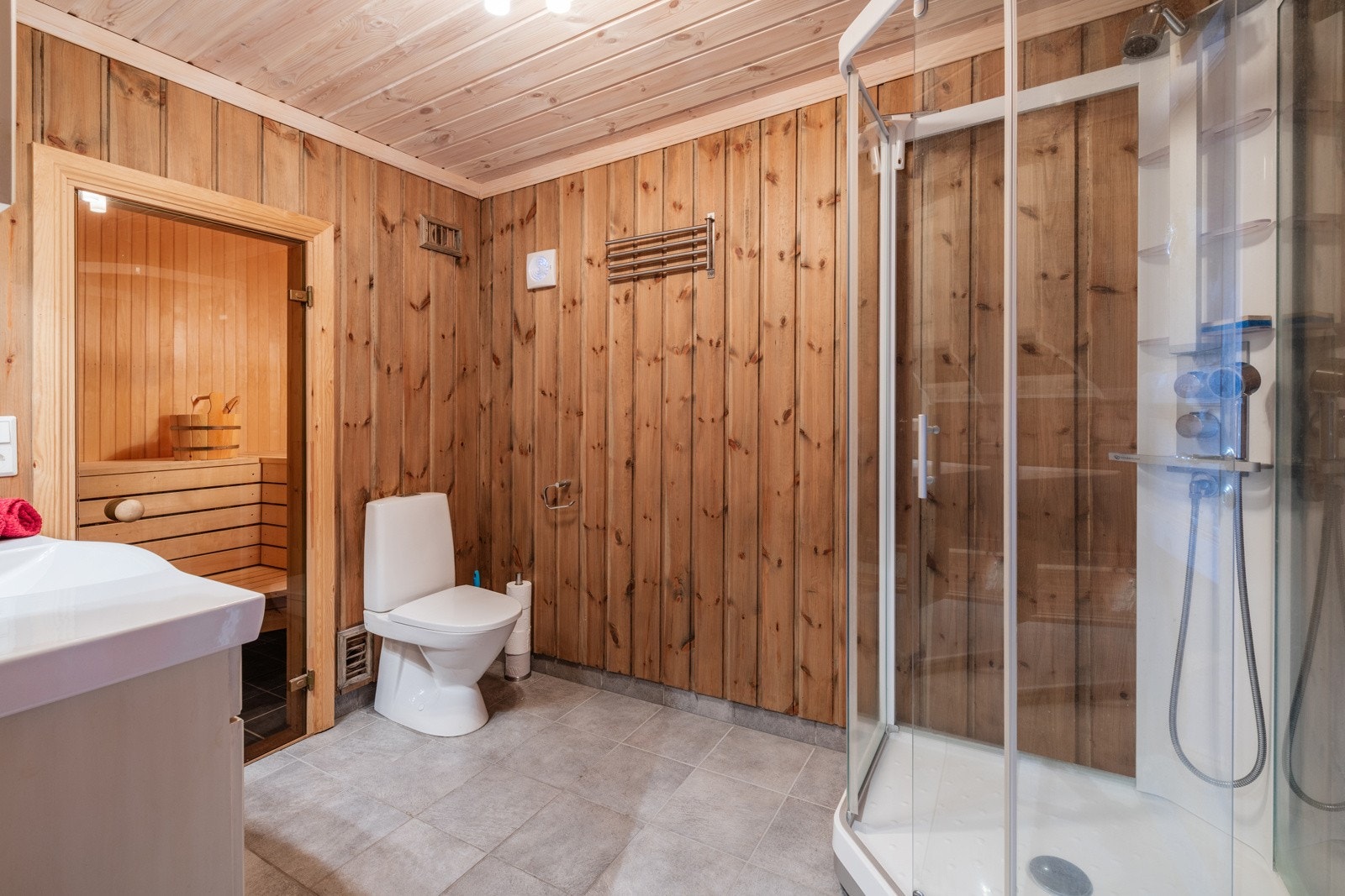 Det er lagt moderne store fliser på gulvet i en lys gråfarge. Galleribilde