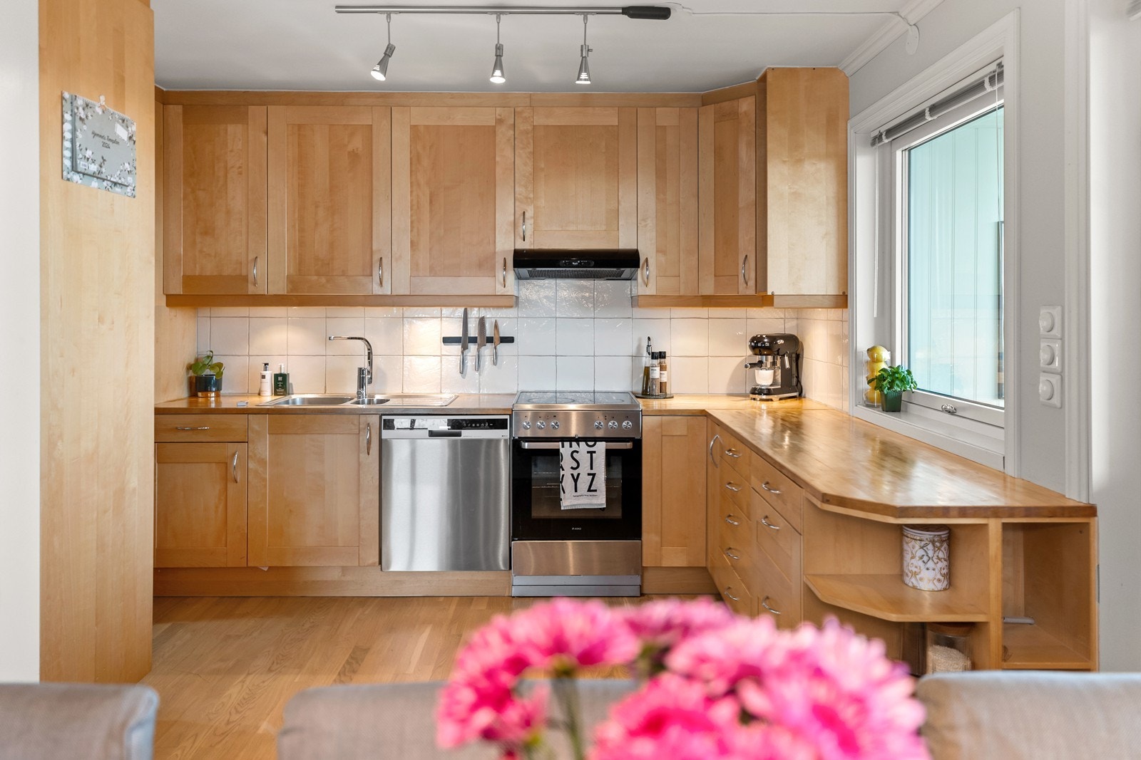 Kjøkkenet har innredning med profilerte fronter og heltre benkeplate Galleribilde