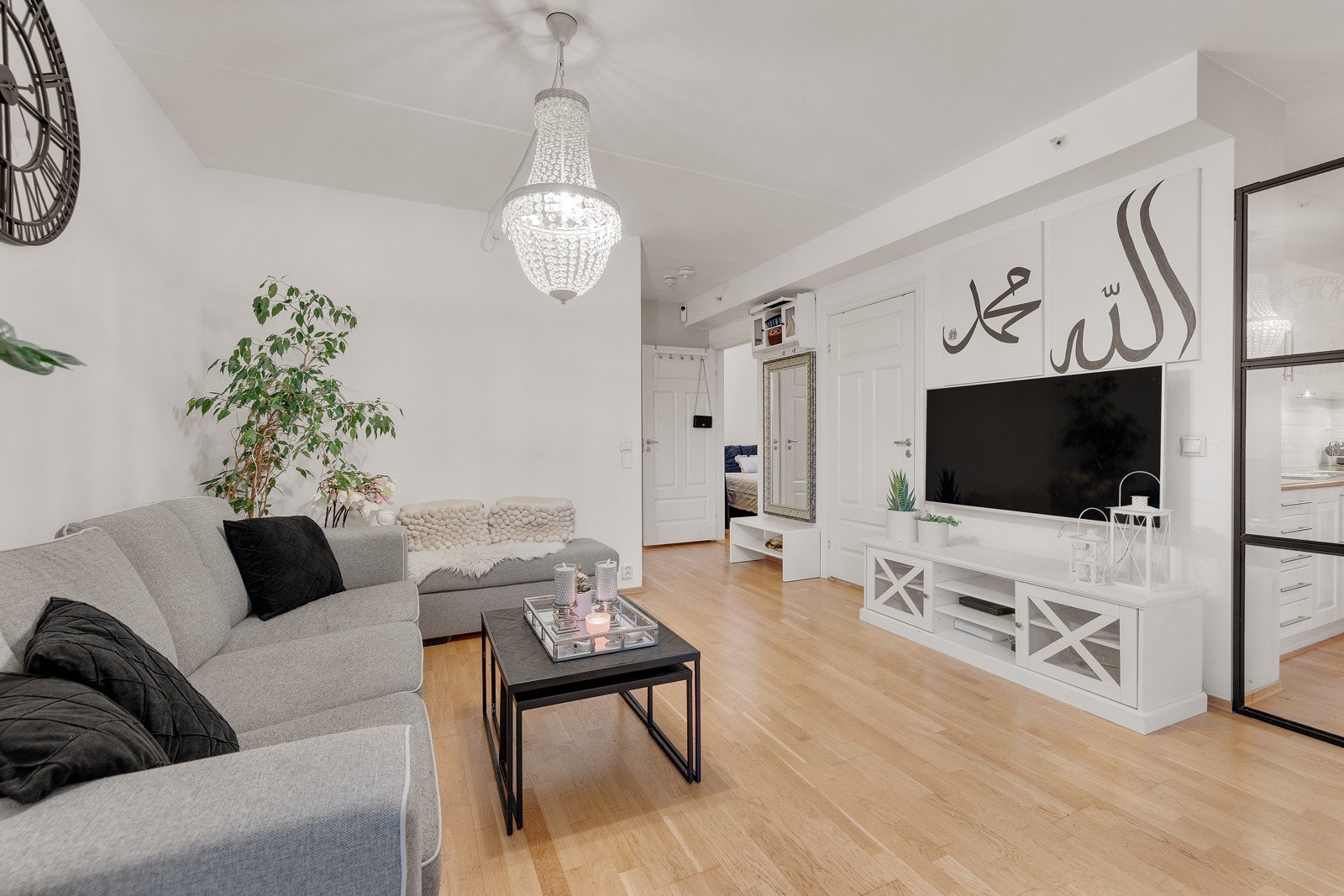 Leiligheten har en lys og romslig stue med parkett på gulv og lysmalte glatte flater. Galleribilde