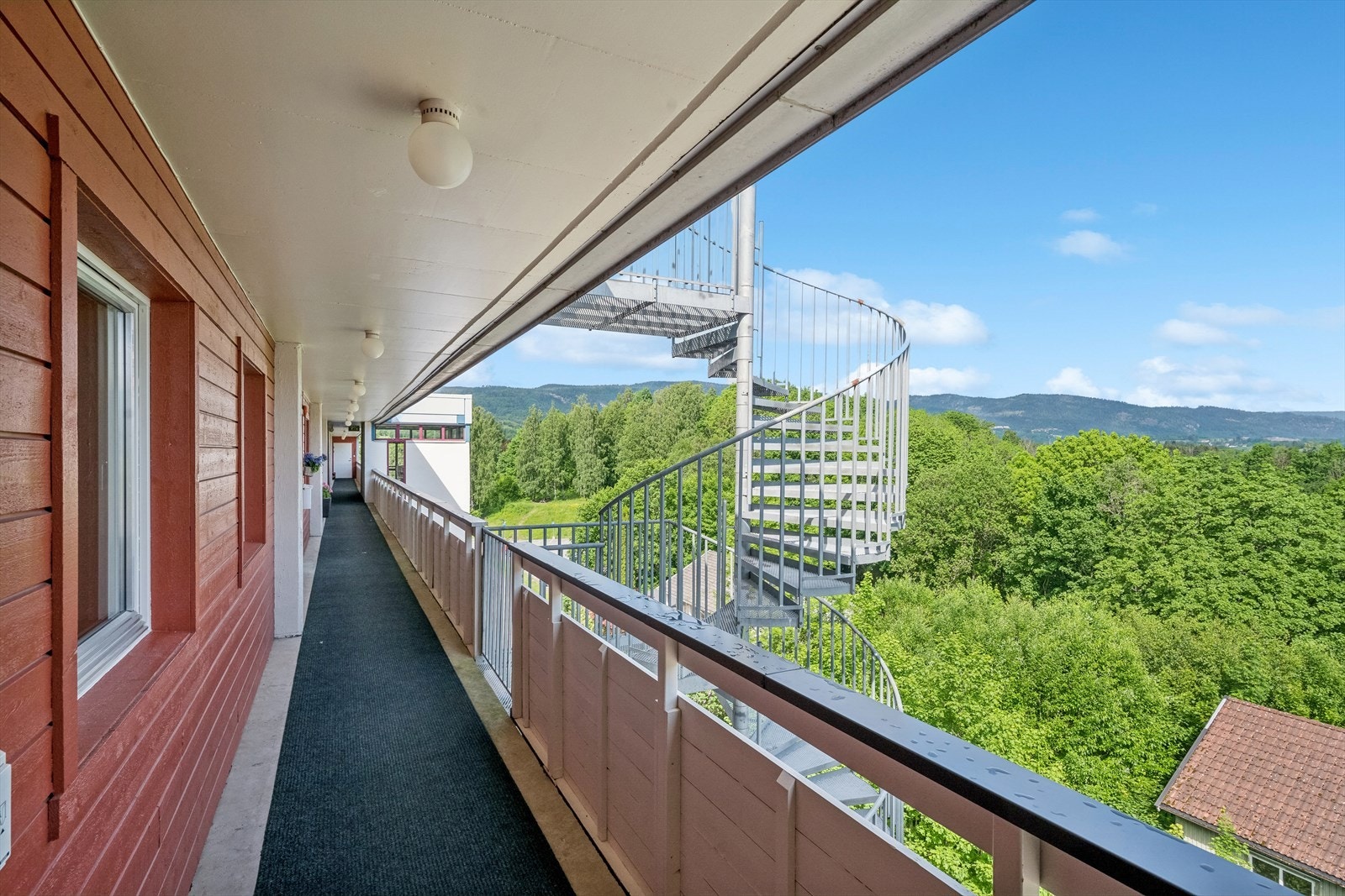 Heisadkomst til etasjeplan og åpen svalgang til leilighetens inngangsparti. Galleribilde