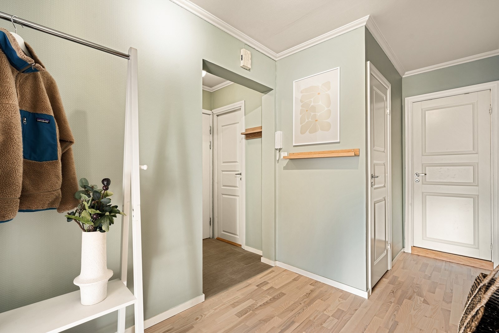 Her har man plass til å henge fra seg yttertøyet og sette fra seg skoene. Fra entré ledes man naturlig ut til resten av leiligheten via gangen. Galleribilde