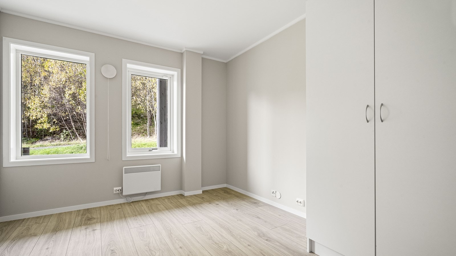 Lyst og fint soverom som vender mot baksiden av bygget Galleribilde