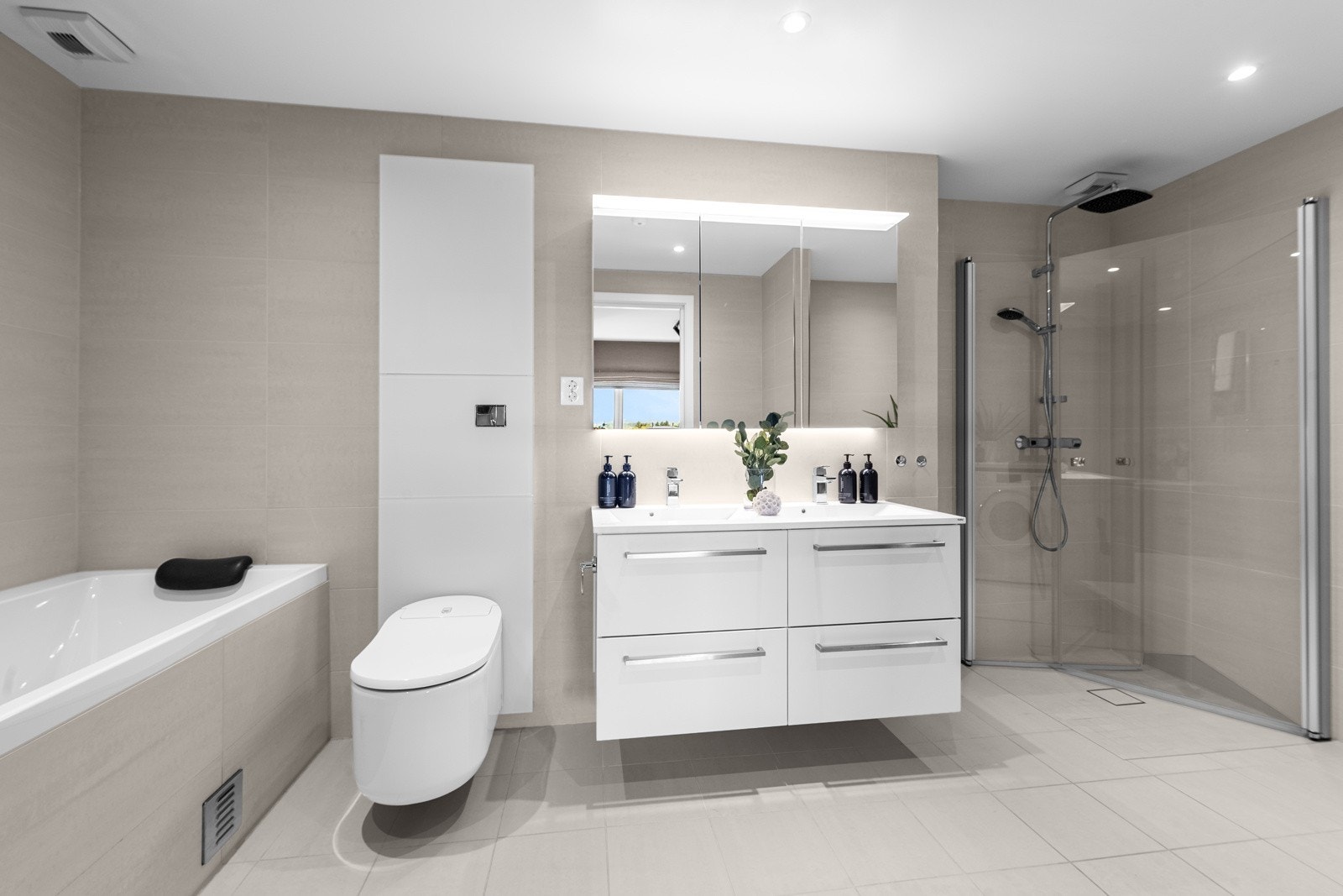 Rommet har lysbeige fliser på gulv og vegger, vannbåren gulvvarme og downlights i taket. Galleribilde