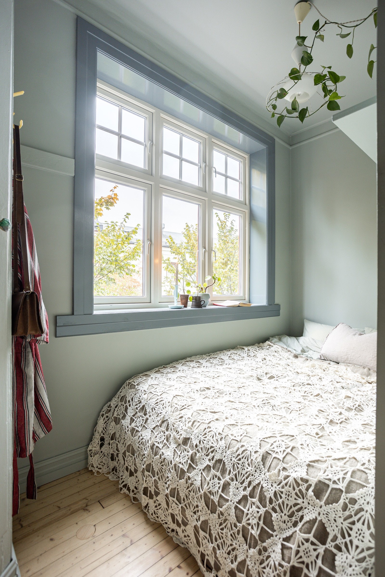 Fra kjøkkenet er det adkomst til det minste soverommet av totalt tre soverom. Soverommet har lyse originale tregulv som ble slipt og behandlet i 2023 og glatte overflater malt i delikate fargetoner. Galleribilde