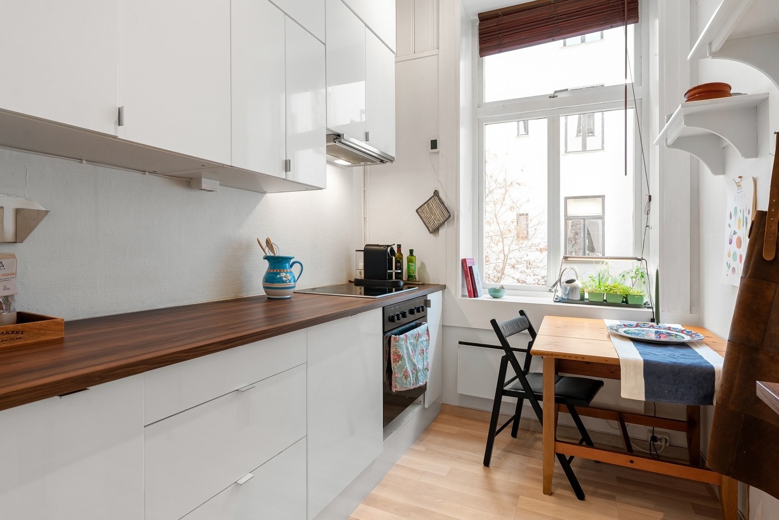 Separat kjøkken som består av lyse fronter og benkeplate i laminat. Galleribilde