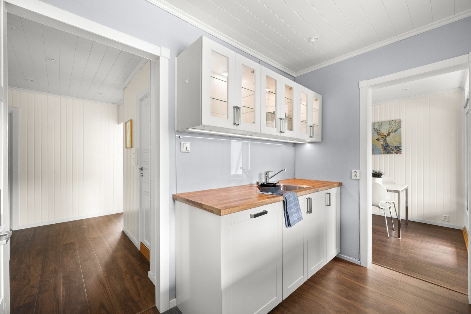 For et luftigere uttrykk er det åpne flater på den ene veggen, og downlights i taket tilfører ekstra lys til arbeidsflatene. Galleribilde