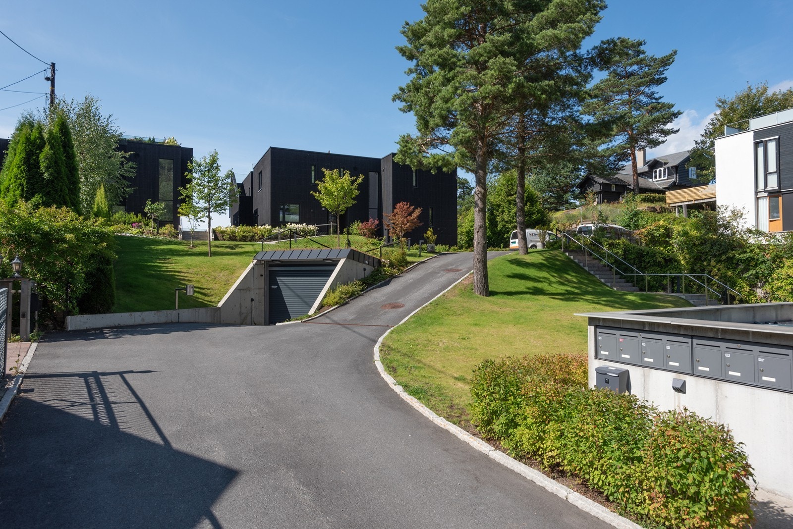 Bebyggelsen ligger godt tilbaketrukket fra gaten og med flott opparbeidet hage/fellesarealer Galleribilde