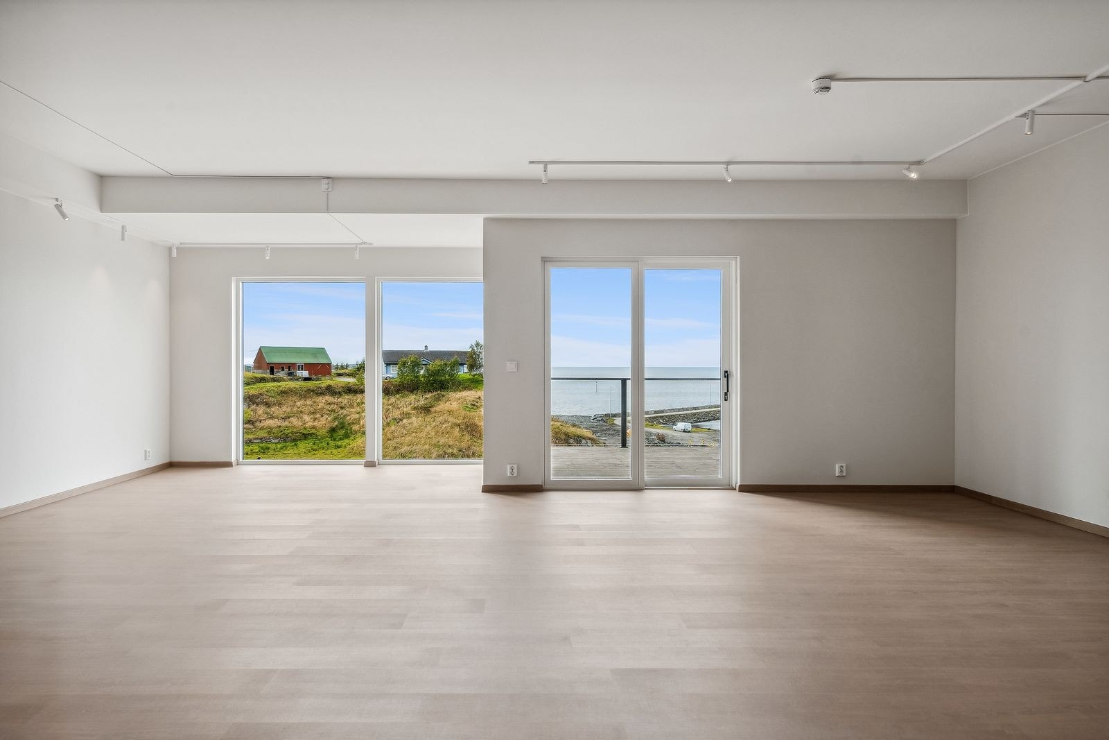 I denne leiligheten har stue og kjøkken ekstra god takhøyde (27o cm). Sammen med vinduer fra gulv til tak gjør det at rommet føles svært luftig og fint Galleribilde