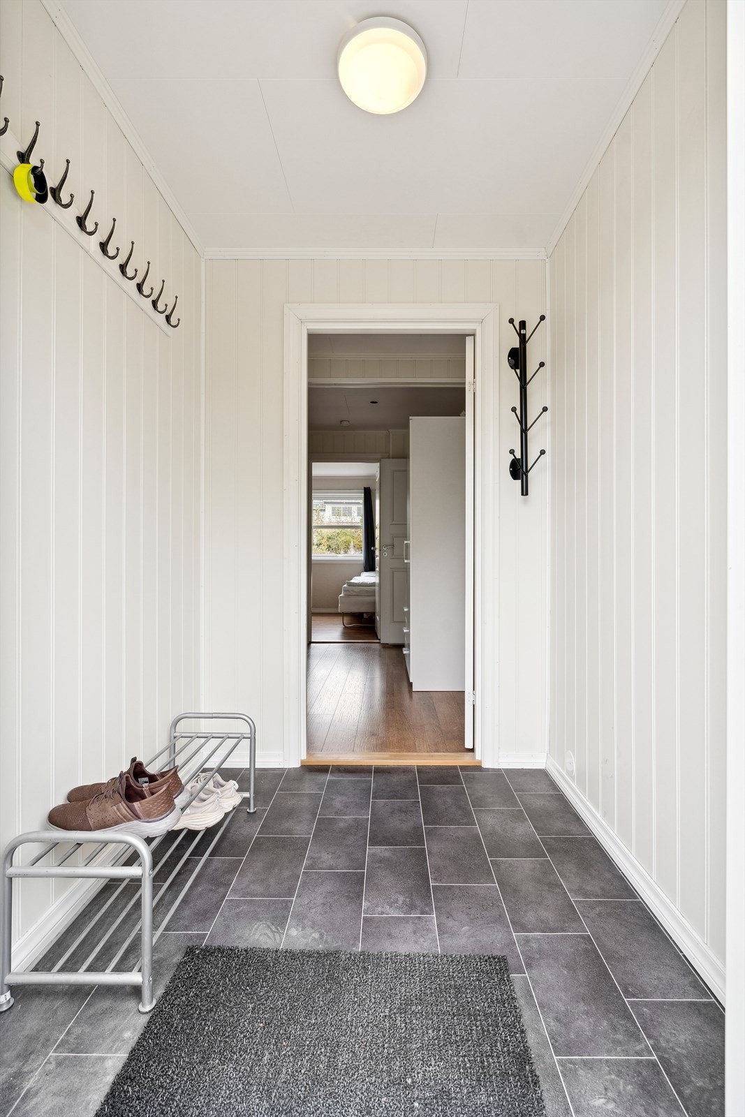 Entréen er lys og fin, og har praktisk knaggrekke for oppheng av yttertøy Galleribilde