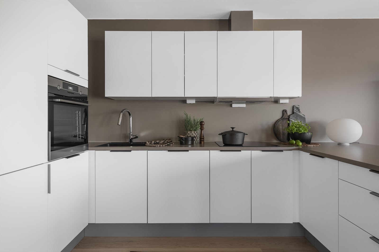 Leiligheten har et stilrent kjøkken fra HTH med god benke og skapplass Galleribilde