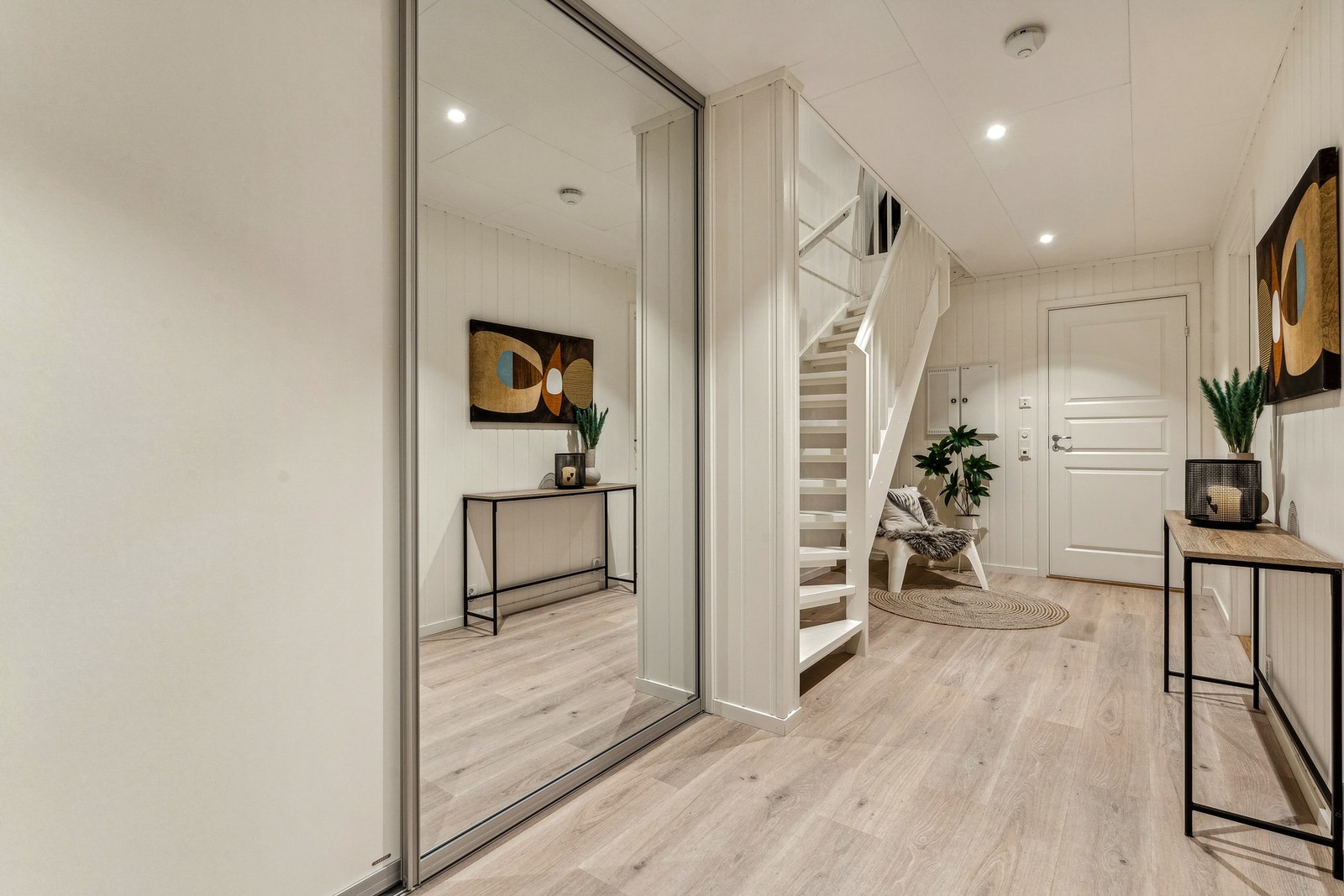 Lys og innbydende entré med praktisk skyvedørsgarderobe. Varme i gulv og downlights i himling. (Foto tatt i tilsvarende og speilvendt nabobolig nr. 130, avvik forekommer). Galleribilde