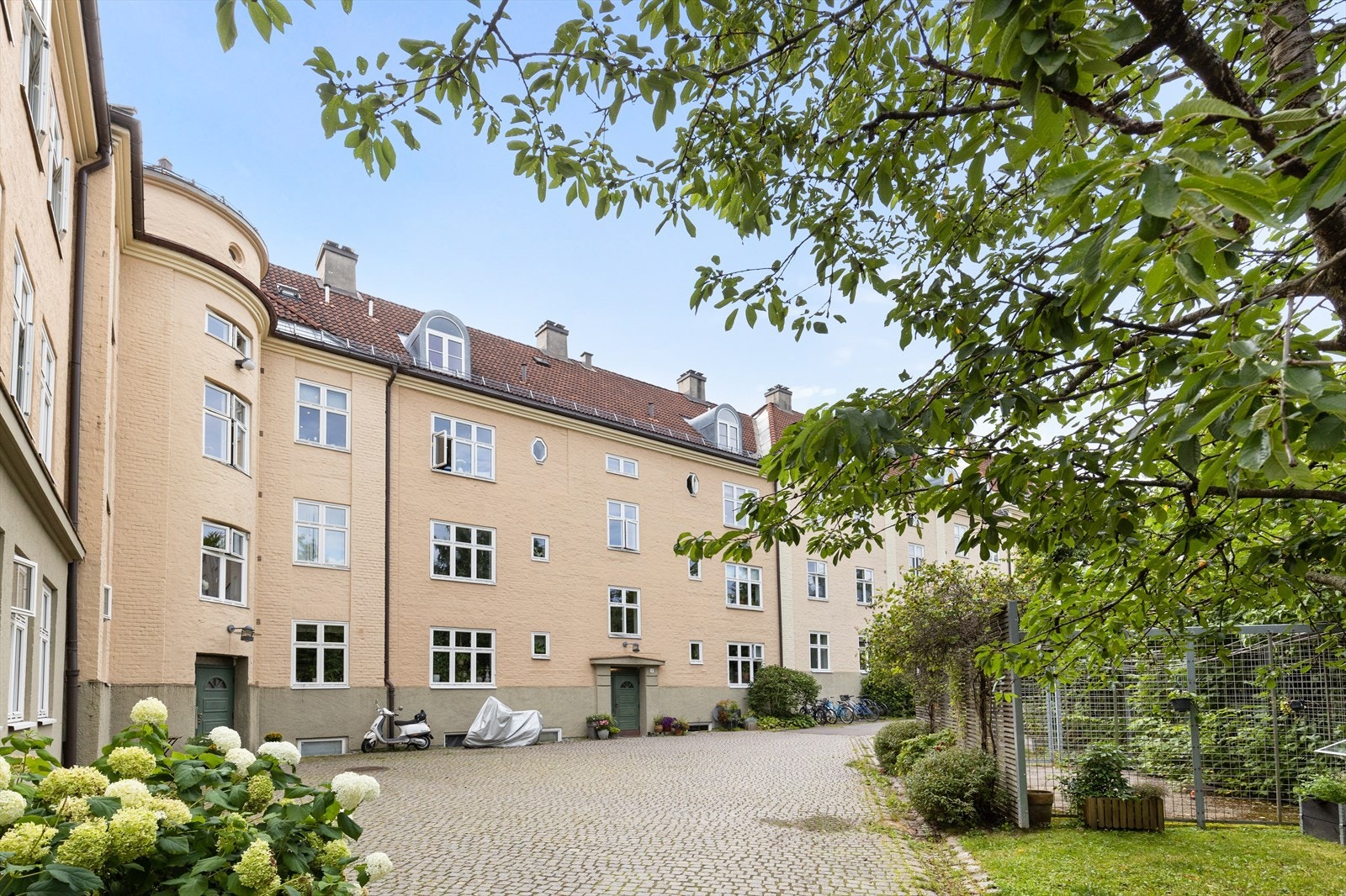Langgården byr på et idyllisk fellesareal med flott beplantning og flere sittegrupper Galleribilde
