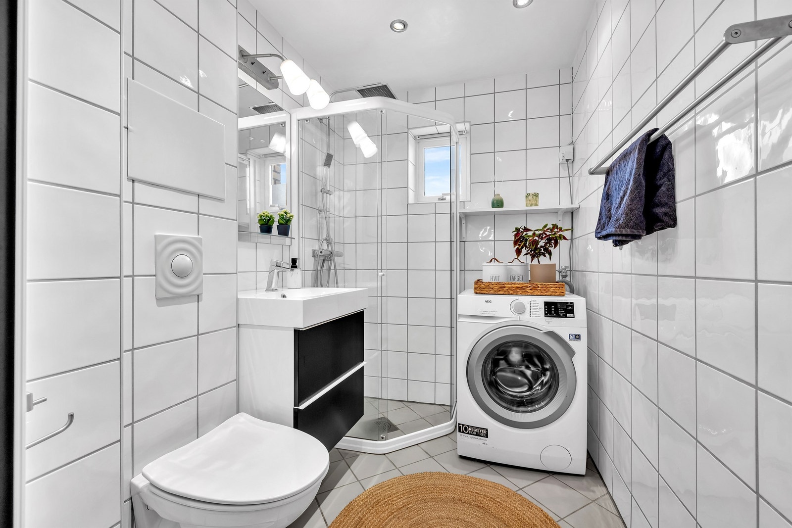 Badet er romslig og praktisk innredet, med vegghengt toalett og dusjhjørne med glassdører. Galleribilde