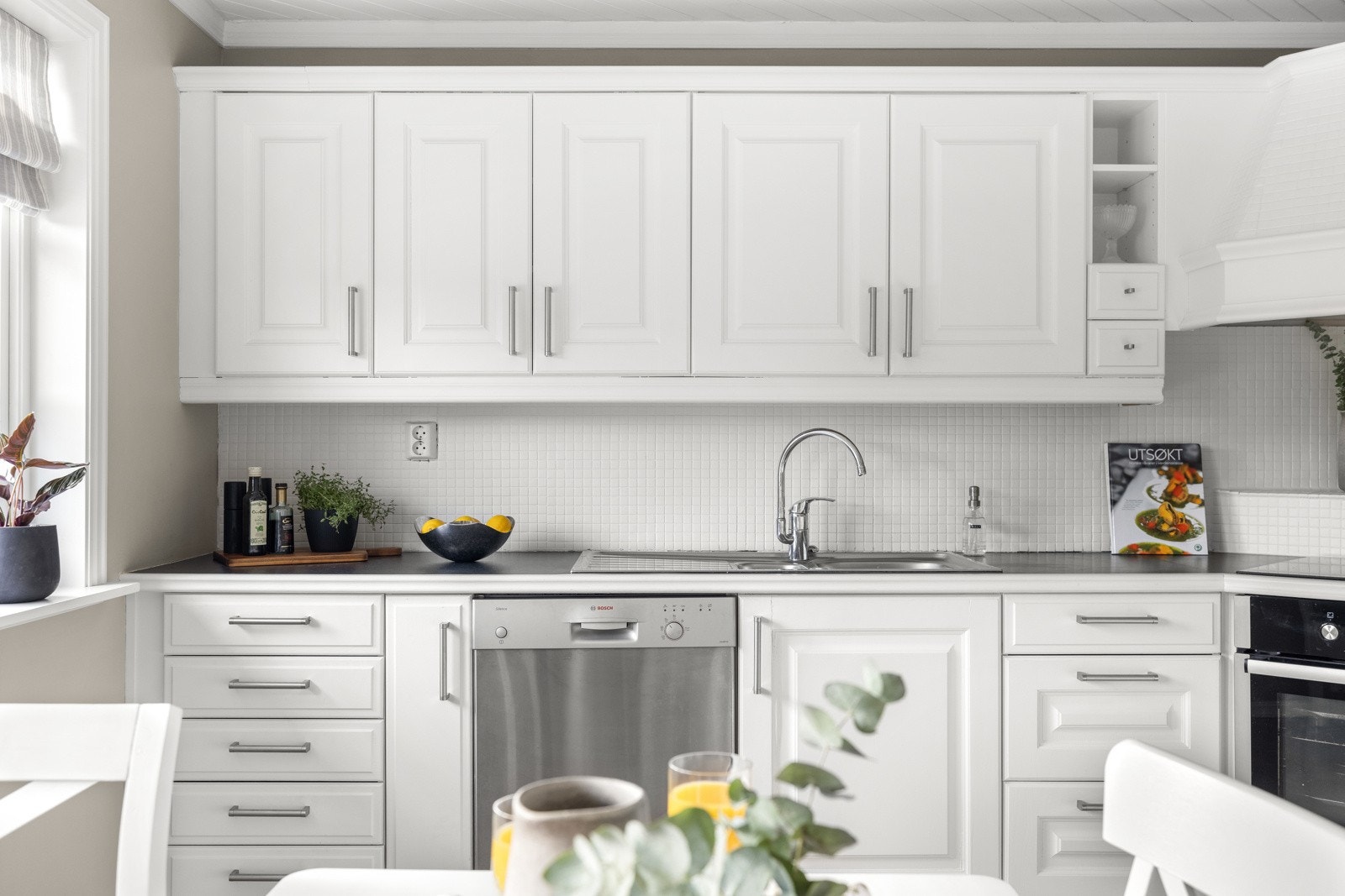 Kjøkkenet er utstyrt med en nedfelt oppvaskkum med ett-greps armatur i krom, oppvaskmaskin, integrert komfyr og nedfelt platetopp. Galleribilde