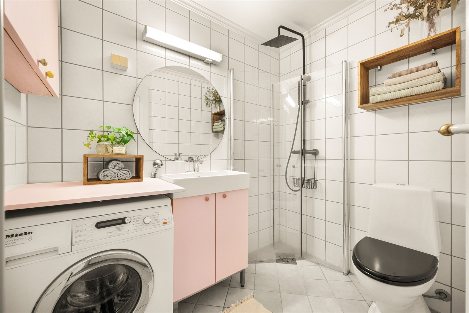 Tidløst bad med flislagte overflater, behagelig gulvvarme og opplegg for vaskemaskin. Ny dusj og dusjdører i 2022. Galleribilde