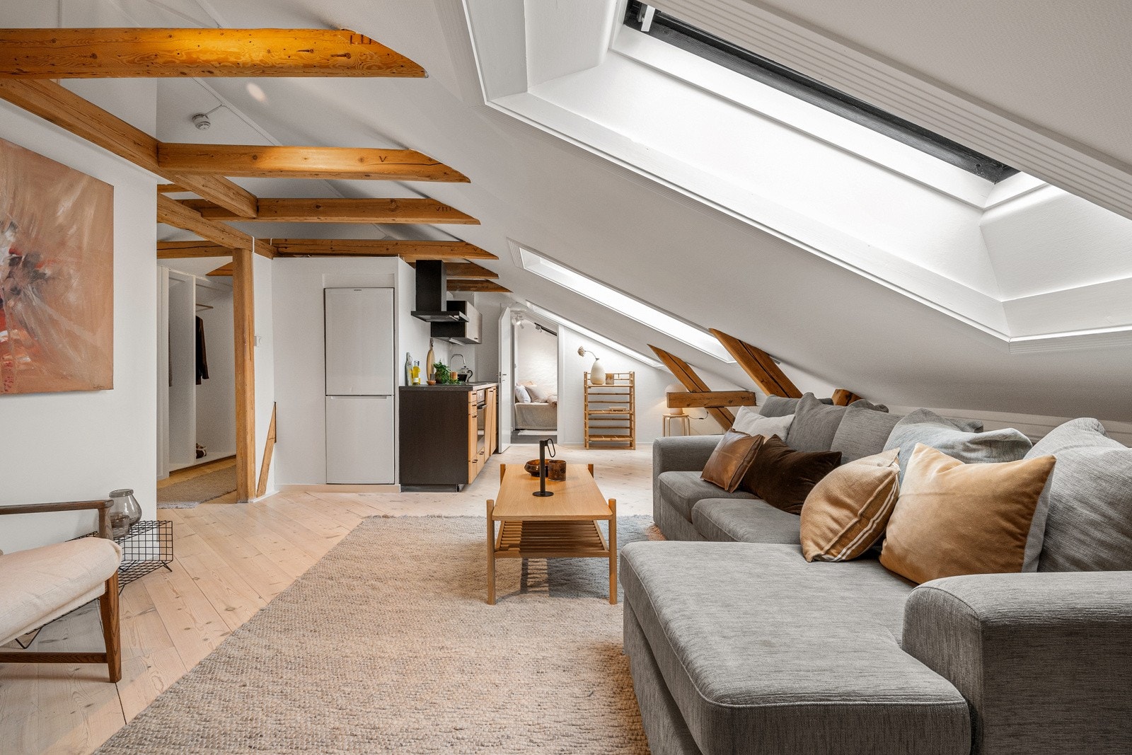 Den ene kjøkkenet ligger i åpen løsning til stuen - dette oppholdsrommet utgjør leilighetens allrom. Galleribilde