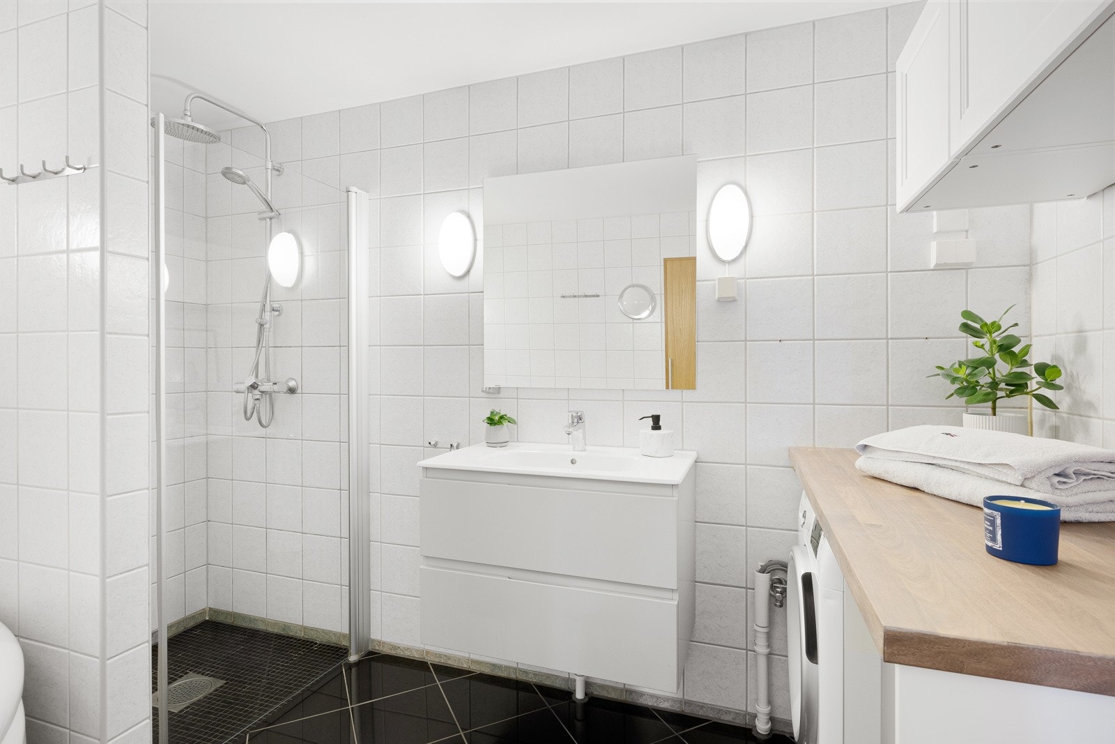 Badet er romslig og smart innredet. Det er både servantinnredning og et høyskap i rommet. Galleribilde