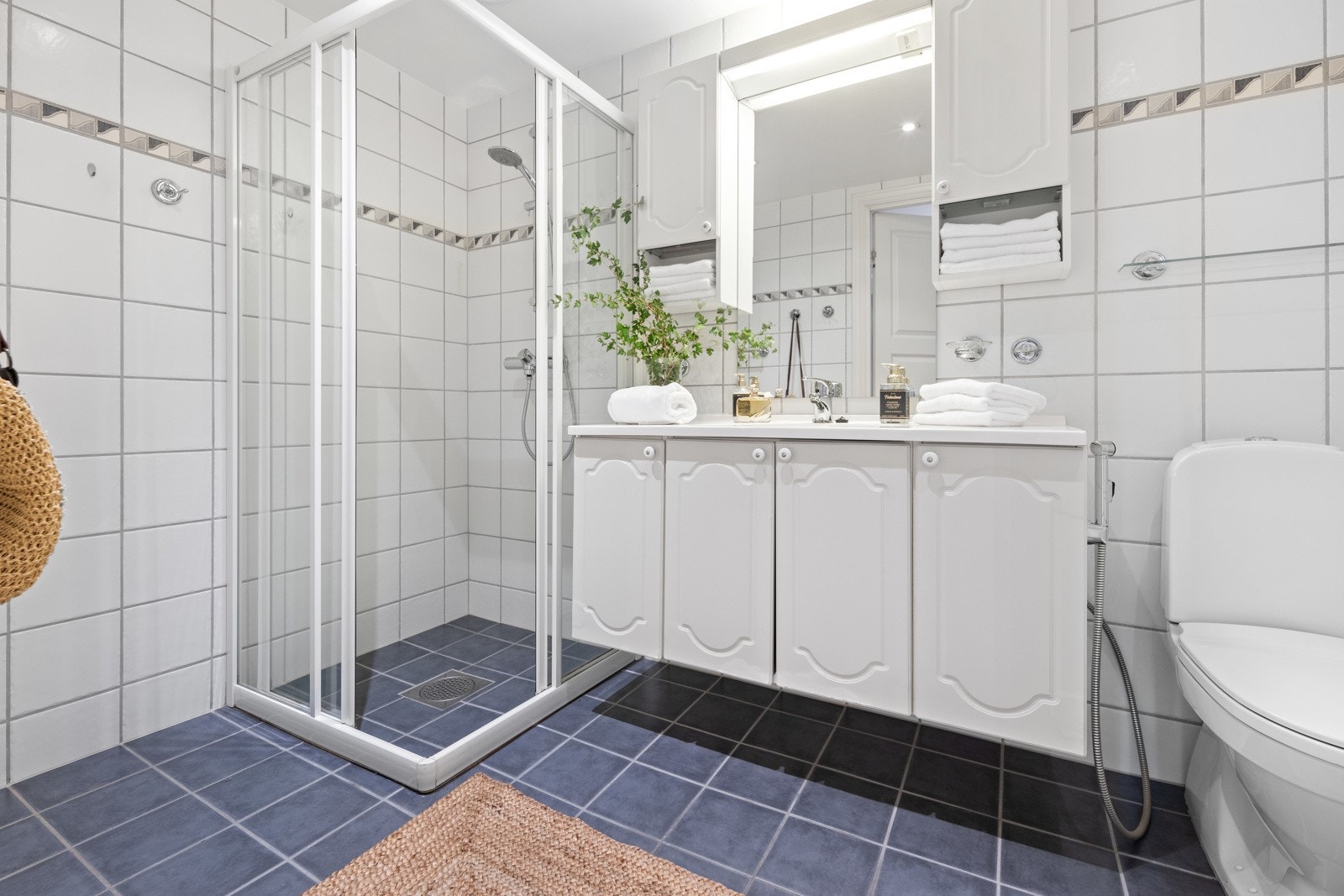 Badet i tilknytning til hovedsoverommet er flislagt og innredet med dusjnisje, servant med servantskap, overskap og klosett. Galleribilde