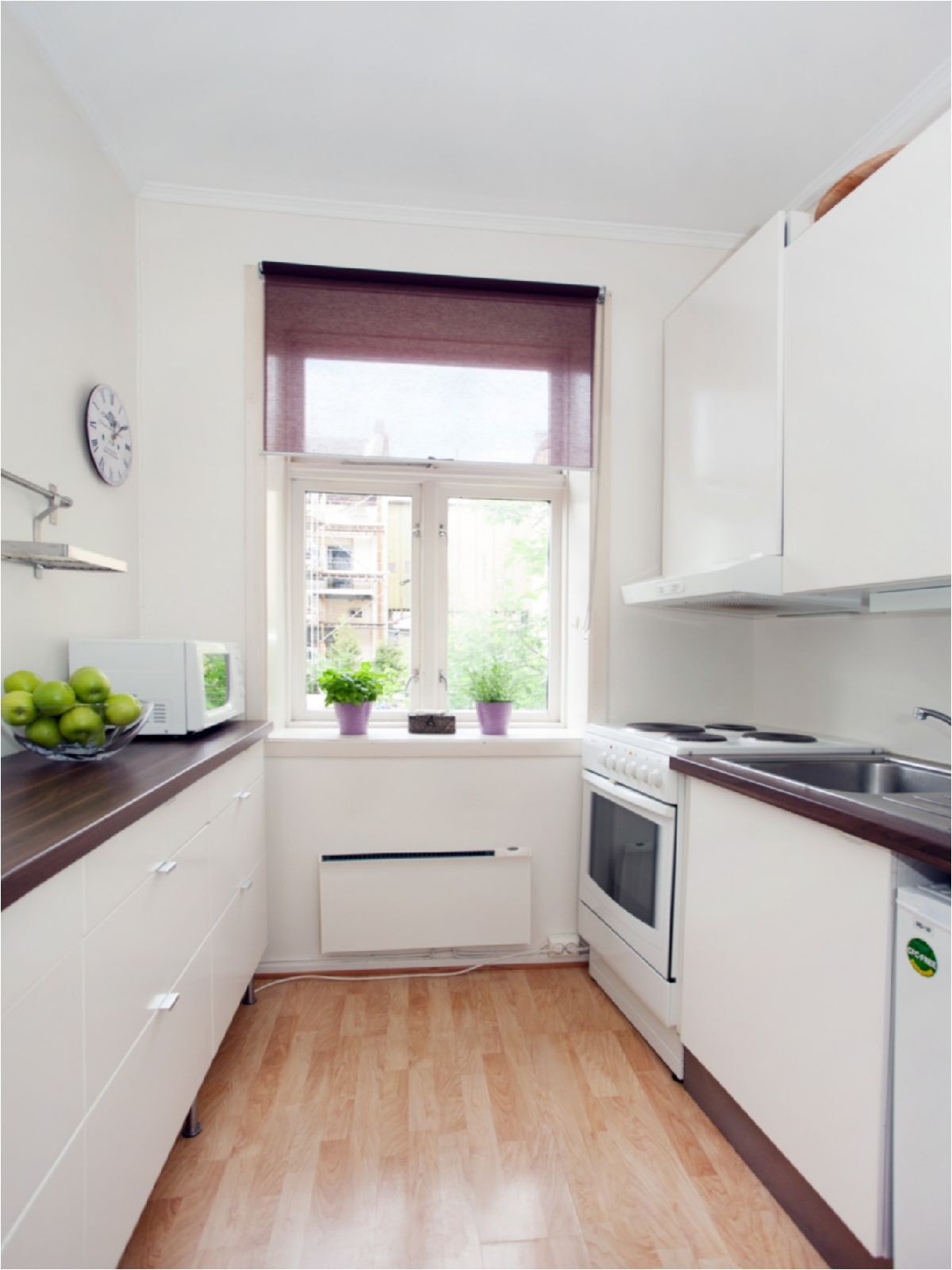 Pent og lyst kjøkken med mye skap- og benkeplass Galleribilde